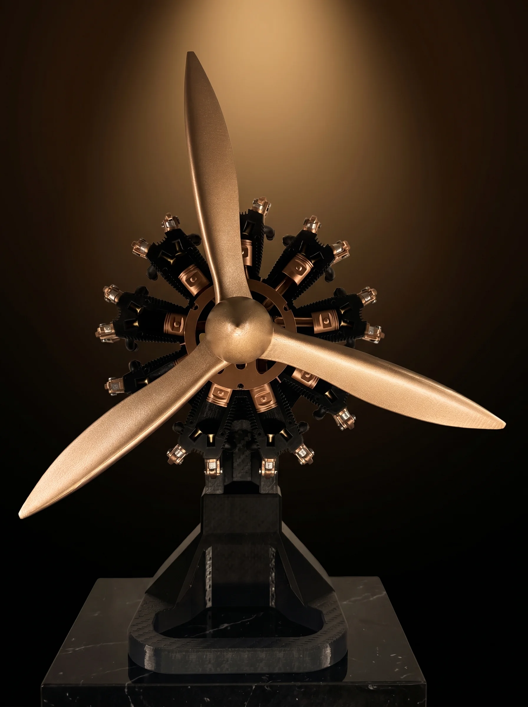 Aero Mécanique R9 — frontal radial star view on a black marble museum pedestal under warm tungsten spotlight
